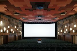 Cinema hall with open curtain, wide screen visible
