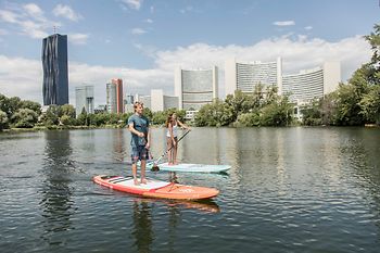 Two people stand up paddling on the Danube