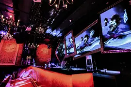 INC. Club Vienna Bar with orange light and chandaliers